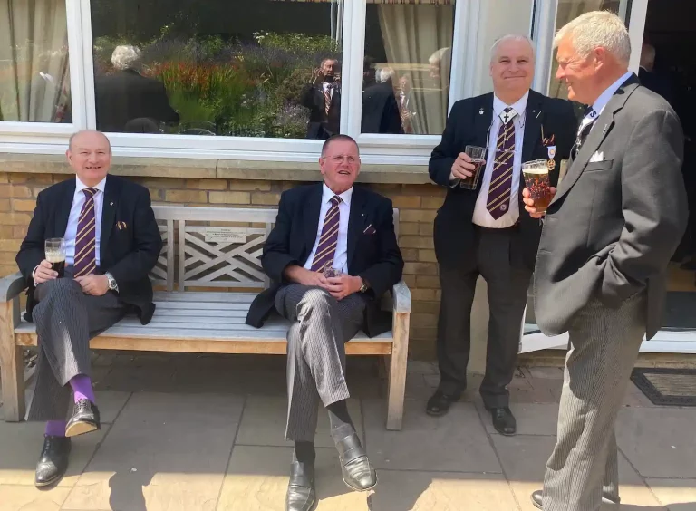 Guests enjoying drink in the sunshine following the annual meeting.