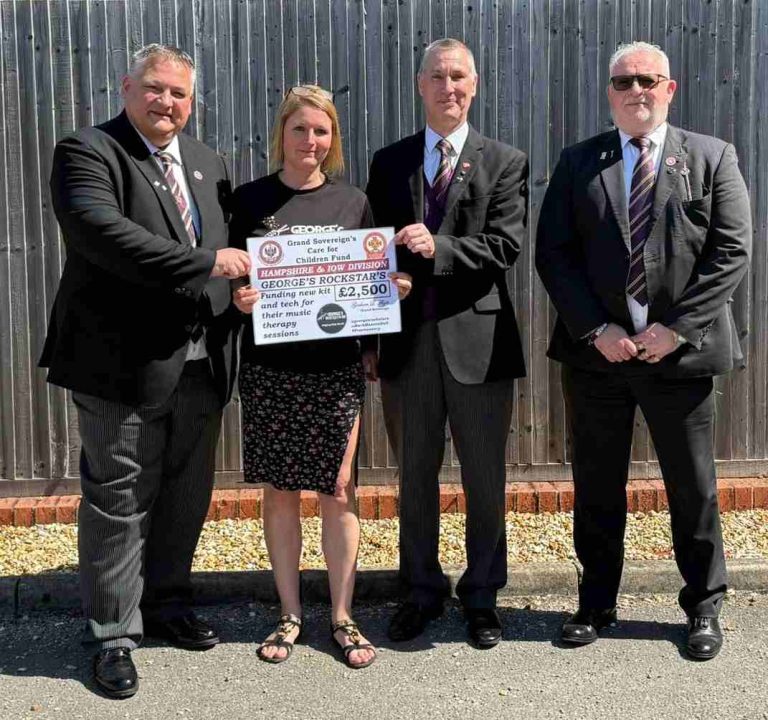 Ill.Kt. Mark Denton (Deputy Intendant General, Amy O'Shaugnessy (co-founder of George's Rockstars), R.Ill.Kt. Steven Groeger (Intendant General) and W.Kt. Paul Hill, presenting £2500 from the Grand Sovereign's Care for Children Fund to the Charity.