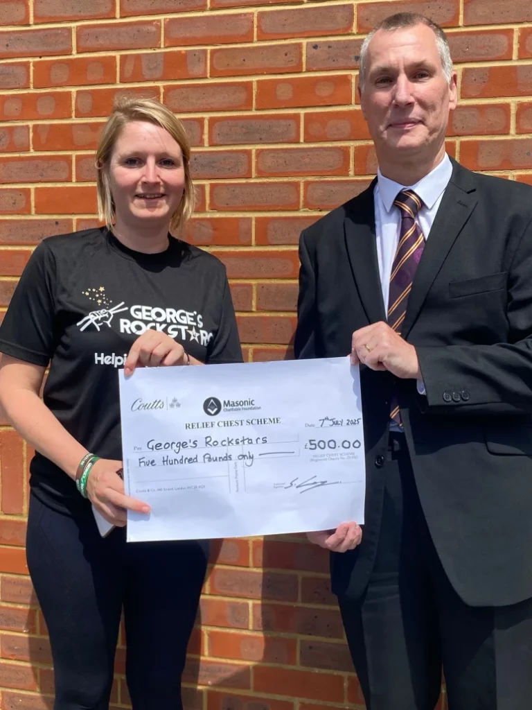Intendant General presenting a cheque to Amy the co-founder of George's Rockstars