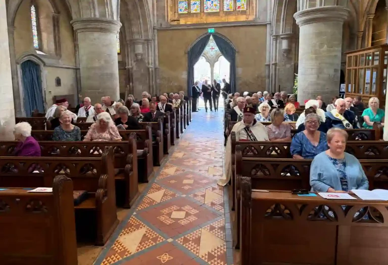 The members (in their Masonic Regalia) and their families seated in St Cross Church awaiting the procession of the Heads of Orders prior to the start of the Service