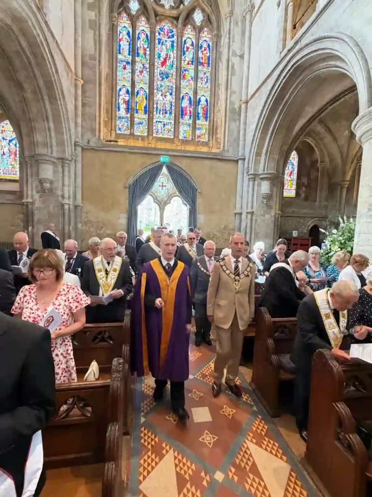 The procession of Heads of Orders into St Cross Church, led by the Intendant General of the Red Cross of Constantine, R.Ill.Kt. Steven Groeger and the PGM/MEGS of the Craft/Royal Arch, R.W.Bro. Jonathan Whitaker.